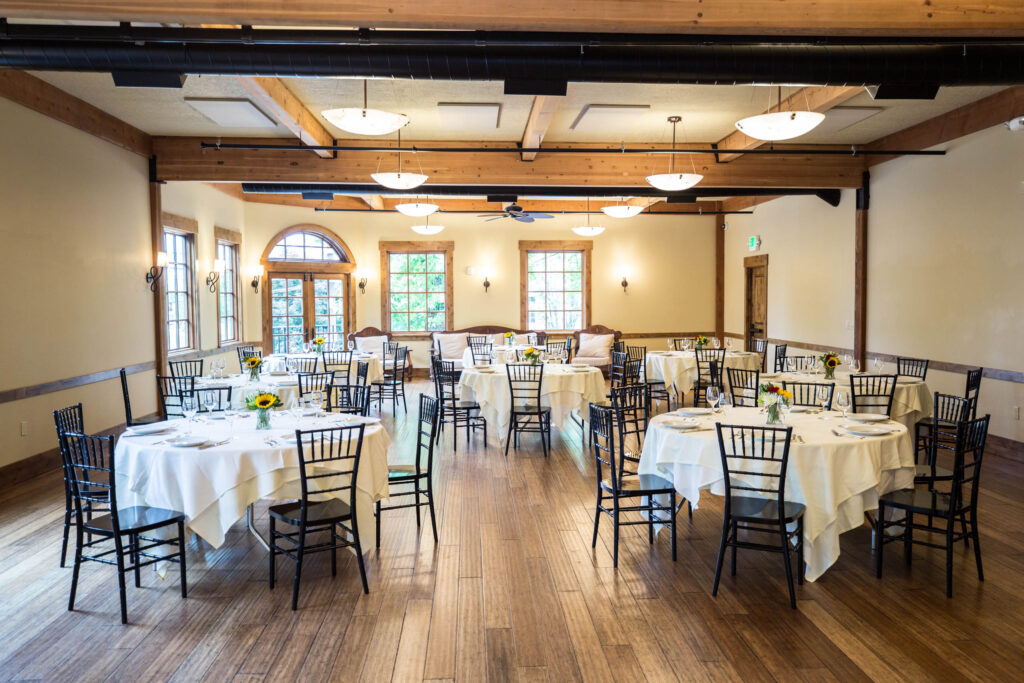Elephants Delicatessen Corbett Room event space set up with tables, chairs, place settings, and flowers