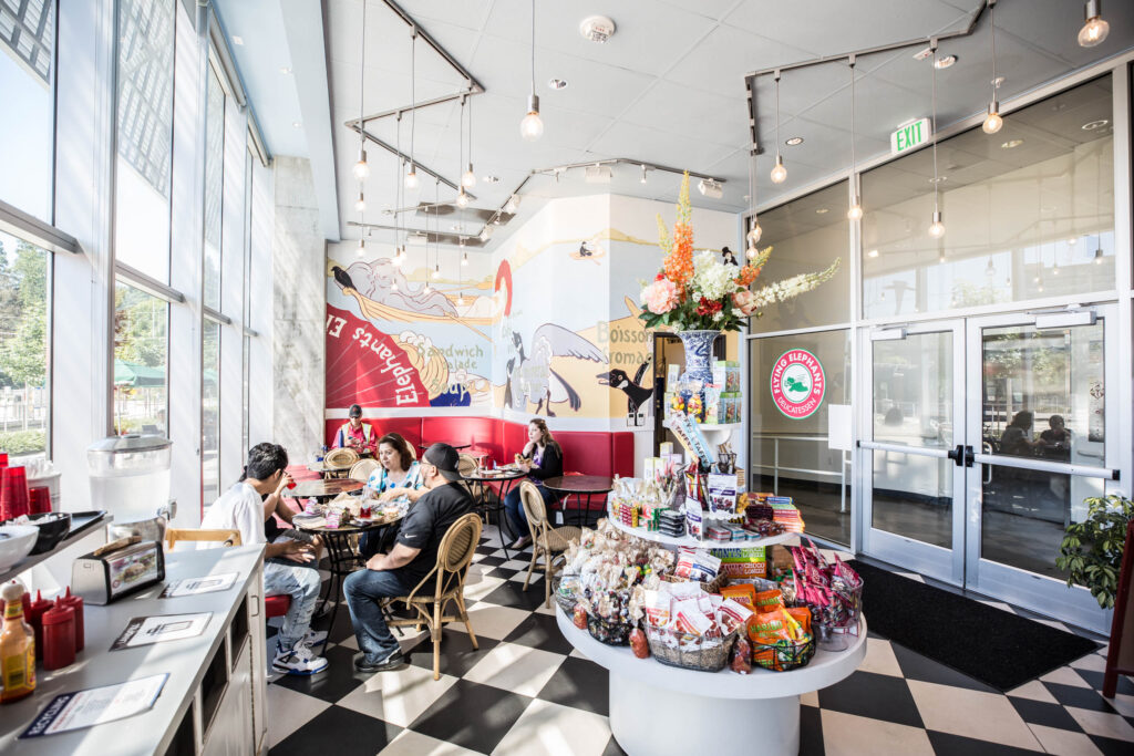 people eating at tables inside Elephants Delicatessen at South Waterfront