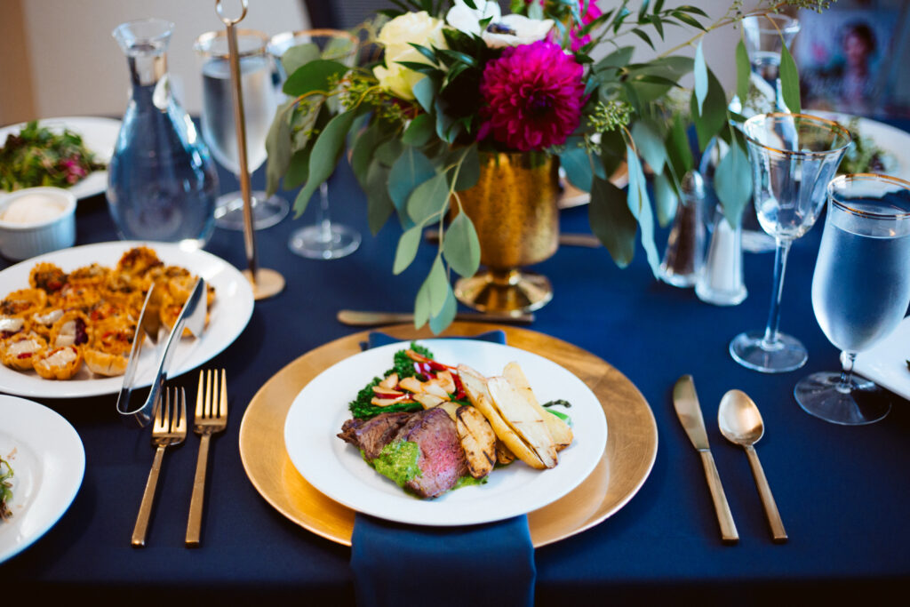 steak and salmon plate on a blue setting