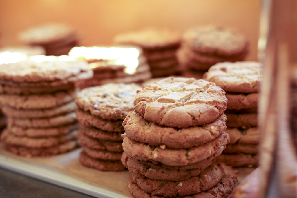 stacks of cookies (peanut butter, chocolate chip, and oatmeal raisin)