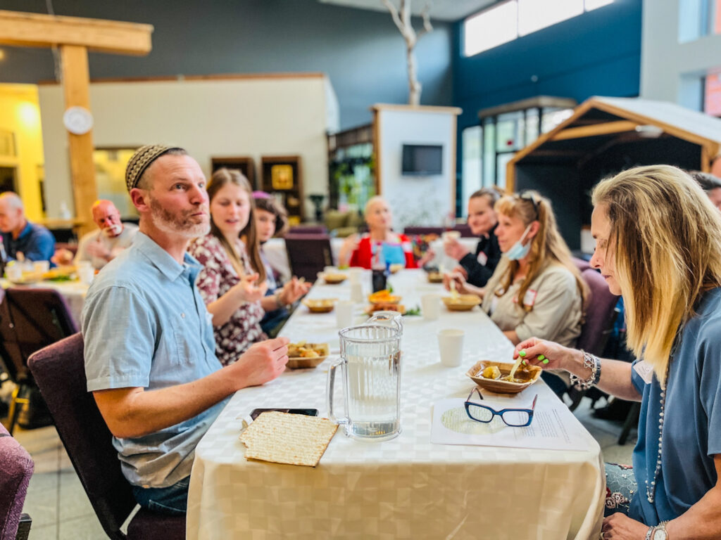 Interior photo of people eating at Eastside Jewish Commons