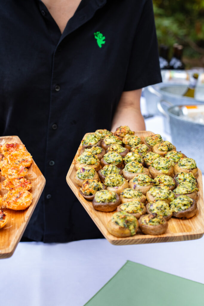 server holding zucchini stuffed mushrooms